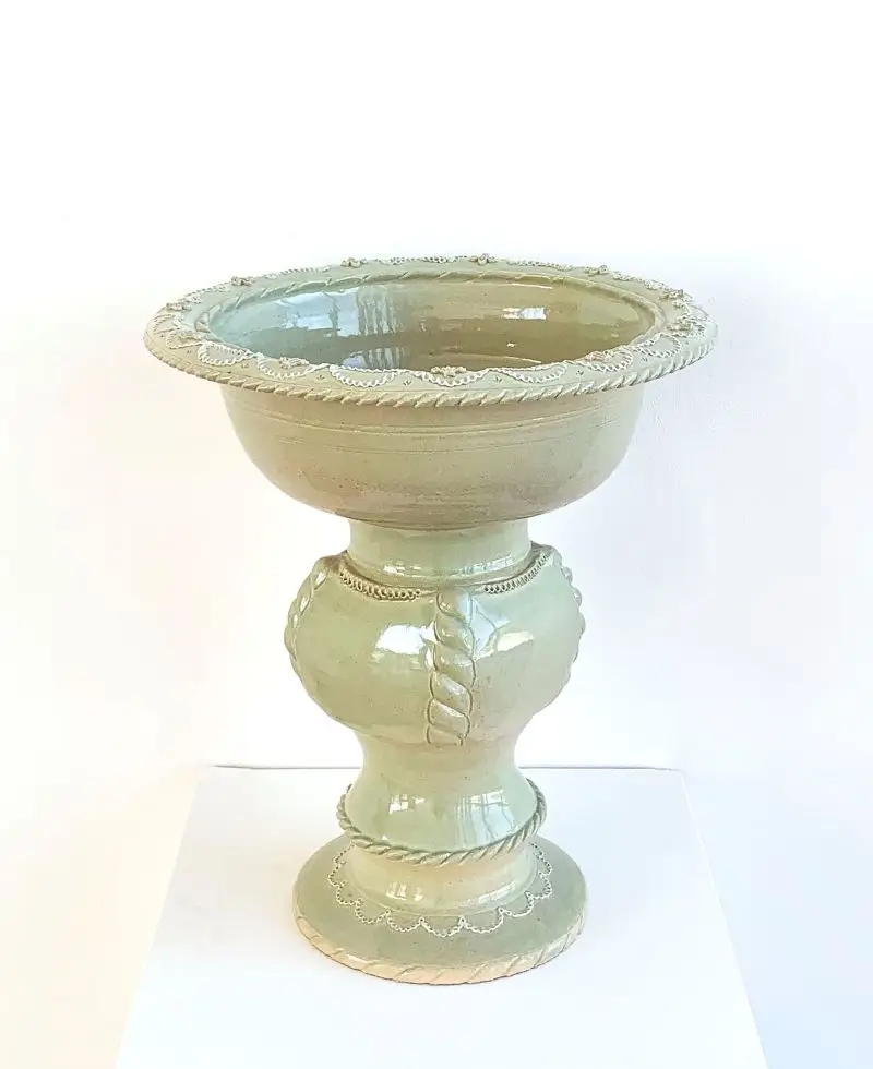 Glazed ceramic pedestal bowl with ornate rope and scalloped detailing.