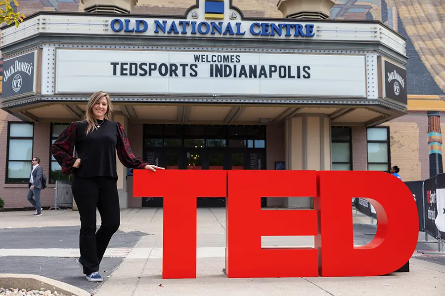 Person standing next to TED logo in front of the Old National Centre