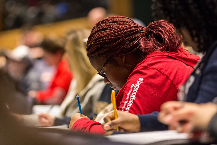 A student taking notes in class
